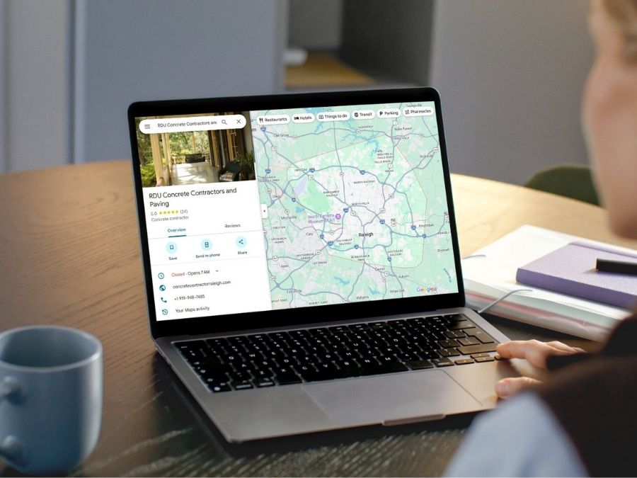 A laptop screen displaying a Google Business Profile for a concrete contractor with service area map, demonstrating how category selection and reviews influence local visibility.